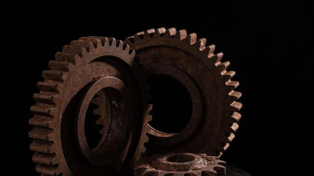 Old rusty metal gears on a black background closeup