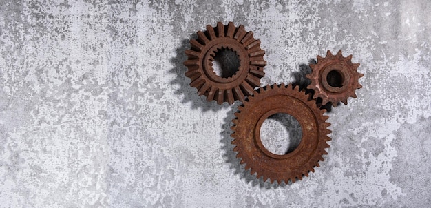 Old rusty metal gears on a gray background