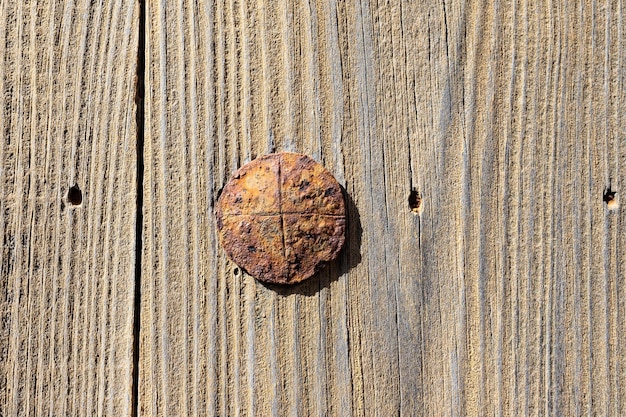 Old rusty nail on a wooden board. Background and texture for design.