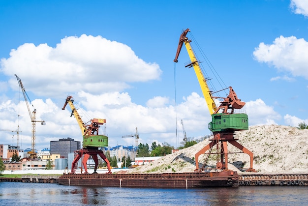 Old rusty port cranes in the industrial zone