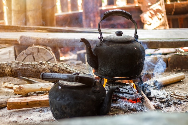 Old rusty tea kettle on the fire