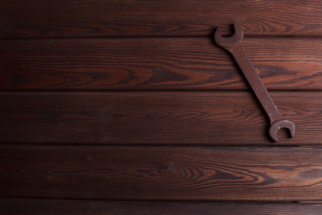 Old Rusty Tools on the Grunge Wooden Background