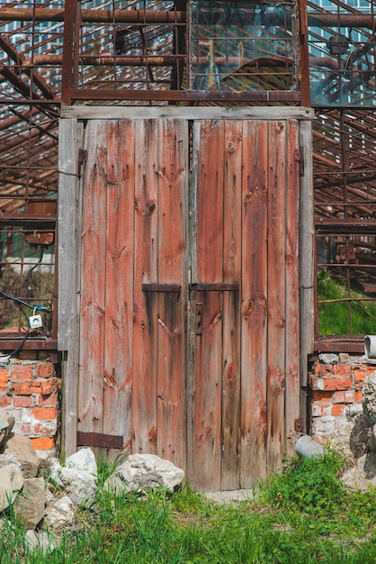 Old rusty wooden door of greenhouse