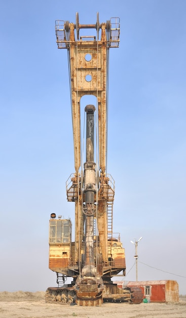 Old rusty yellow excavator