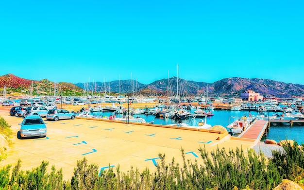 Old Sardinian Port and marina with ships at Mediterranean Sea in city of Villasimius in South Sardinia Island Italy in summer. Cityscape with Yachts and boats