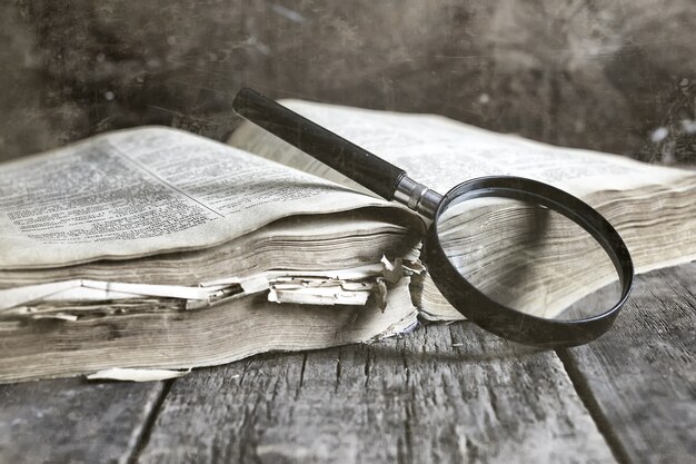 Old scratched effect on photo magnifying glass and old book