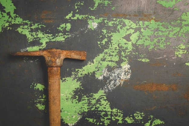 Old and scratched hammer on metal surface