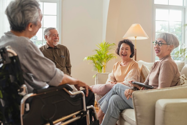 Old senior asian friends retired people hapiness positive laugh smile conversation together at living room at nursing home Seniors participating in Group Activities in Adult Daycare Center