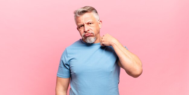 Old senior man feeling stressed, anxious, tired and frustrated, pulling shirt neck, looking frustrated with problem