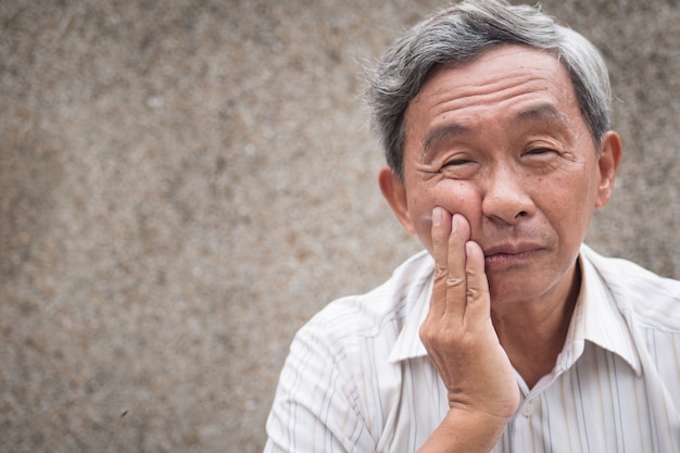 Old senior man with toothache