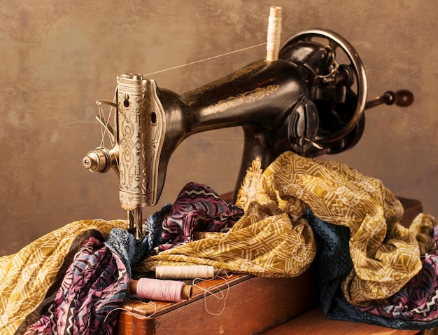 The old sewing machine, fabric and sewing thread.