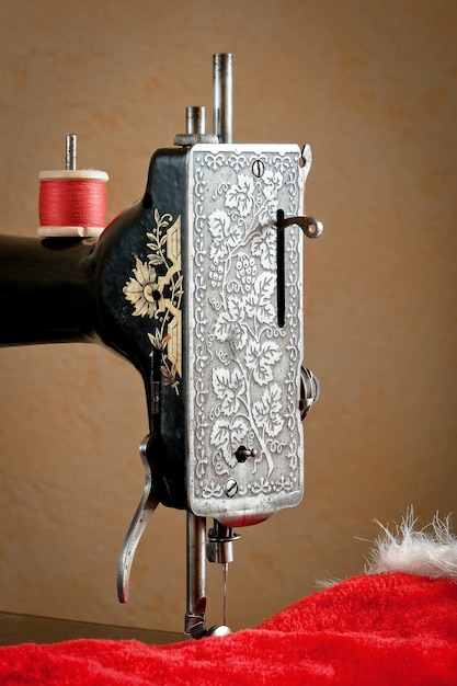 Old sewing machine with red thread