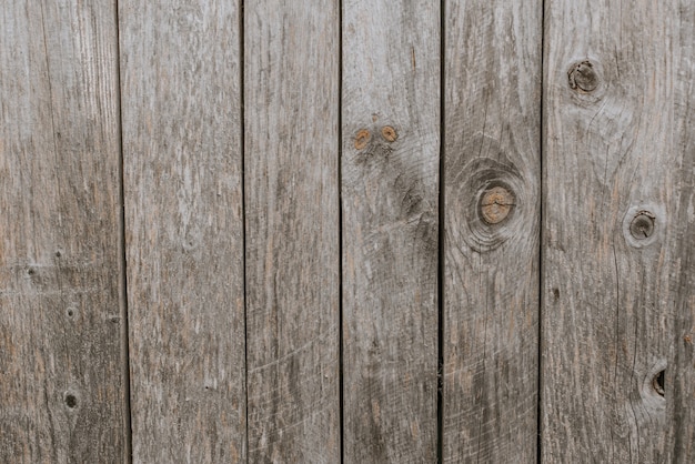 Old shabby gray fence made of wooden boards. background texture wall