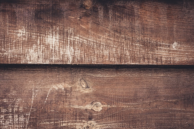 Old shabby wooden boards, dark brown background of wood. Weathered table of alder, oak. Vintage timber texture, backgrounds.