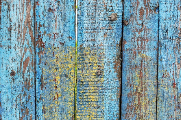 Old shabby wooden fence background with a trace of ads