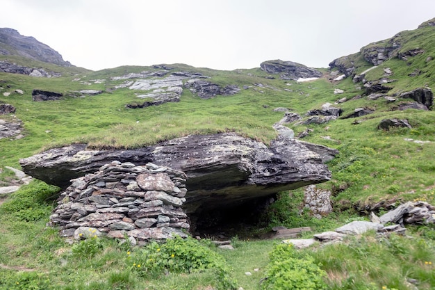 An old shelter under the big stone Hiking travel outdoor concept journey in the mountains Kals am Grossglockner Austria