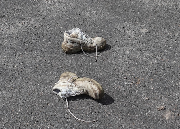 old shoes with copy space for text left on an ashpalt road stylish and fashion accessories