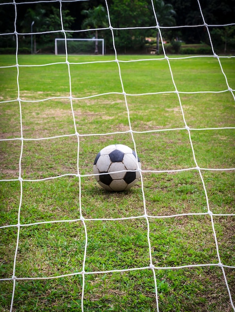 Old soccer ball on field