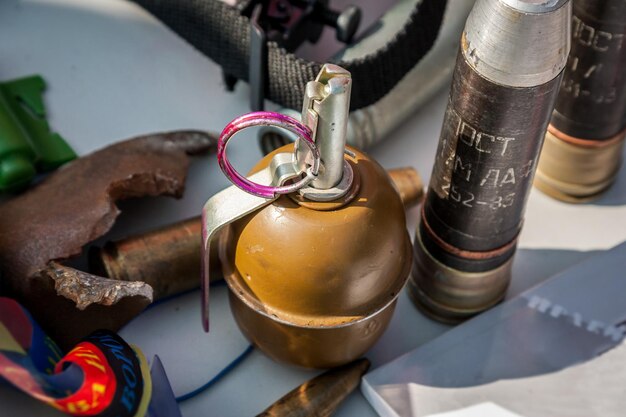 Photo old soviet hand grenade rgd5 against the background of shells and fragments