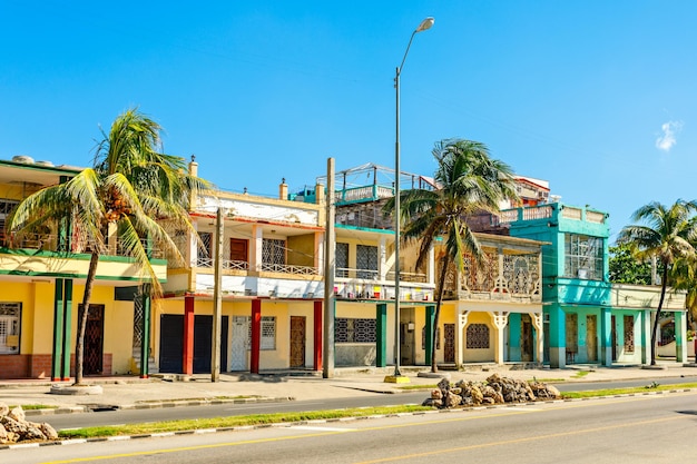 Old spanish colonial houses with palms along the street in the c