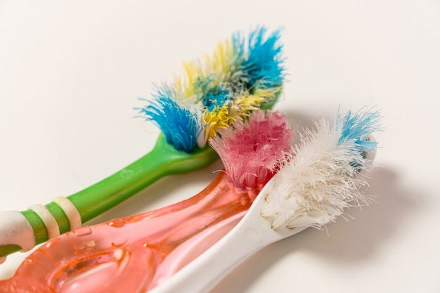 Old, spoiled, disheveled, colored toothbrushes renewal, replacement