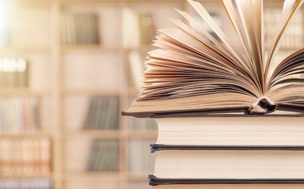 Old stacked books on background