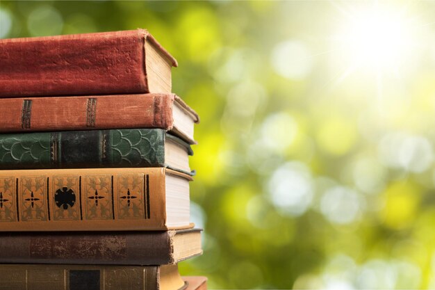 Old stacked books on blurred background