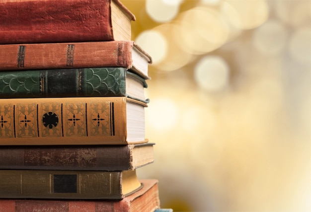 Old stacked books on wooden background