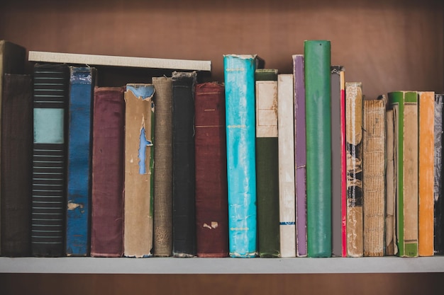 Old stacked books on wooden table