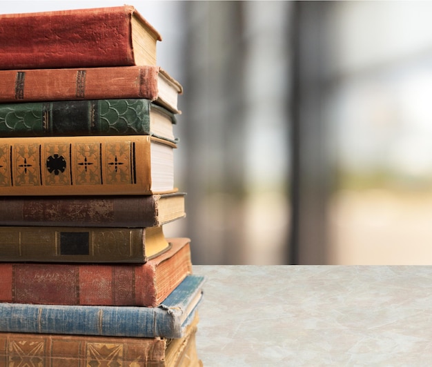 Old stacked books on wooden table