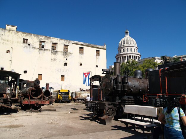 Old steam engines by building against clear sky