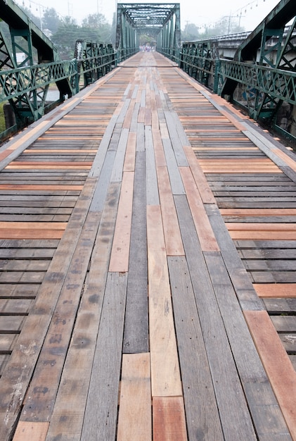 Old steel bridge with the wooden pathway.