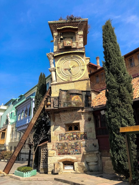 Old stone ancient carved beautiful antique european clock tower with dial on the background