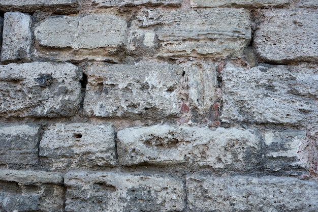 Old stone bricks wall texture close up.