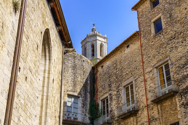 Old stone houses and cathedral tower emerging above the roofs Gerona Spain