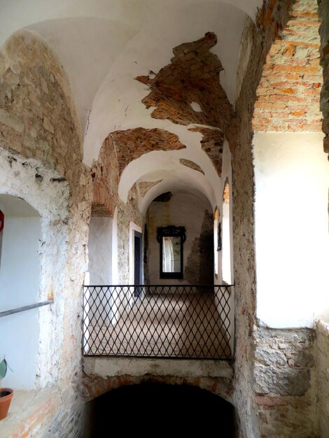 Old stone masonry plaster walls arched corridor old medieval castle Chinadiyevo Castle of St Miklos