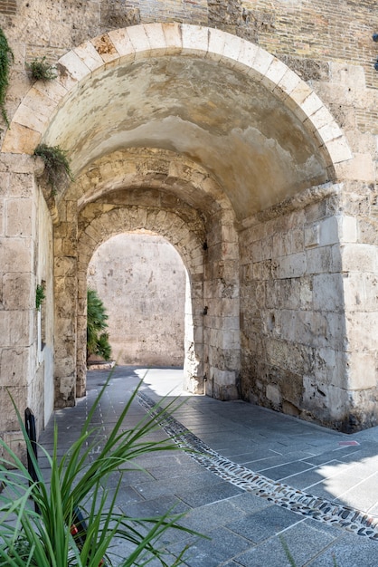 Old stone passage in the stone wall of an european city