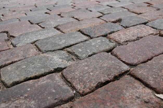 Old stone paved avenue street road, low angle.