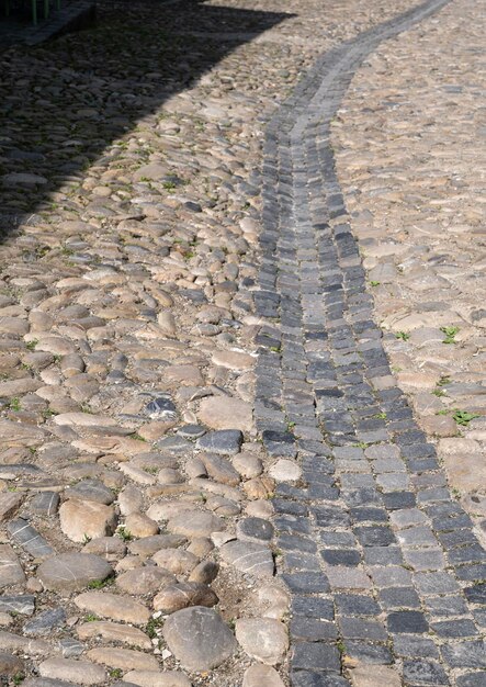 Old stone paved road water ditch in the city