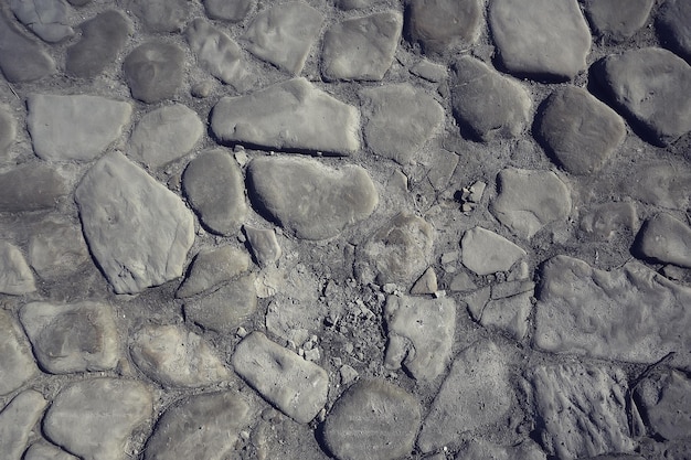 old stone pavement background / abstract pavement, large cobblestones, old road texture