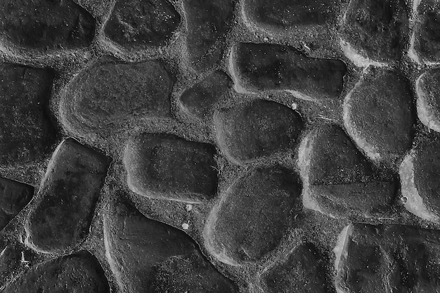 Photo old stone pavement background / abstract pavement, large cobblestones, old road texture