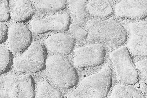 old stone pavement background / abstract pavement, large cobblestones, old road texture