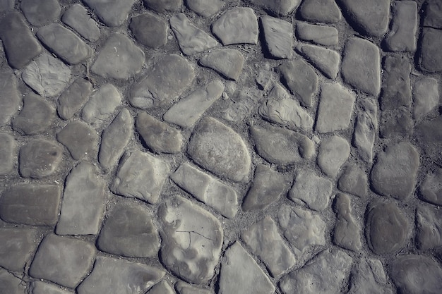 old stone pavement background / abstract pavement, large cobblestones, old road texture