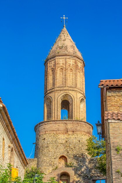 Old stone tower with an orthodox cross georgia