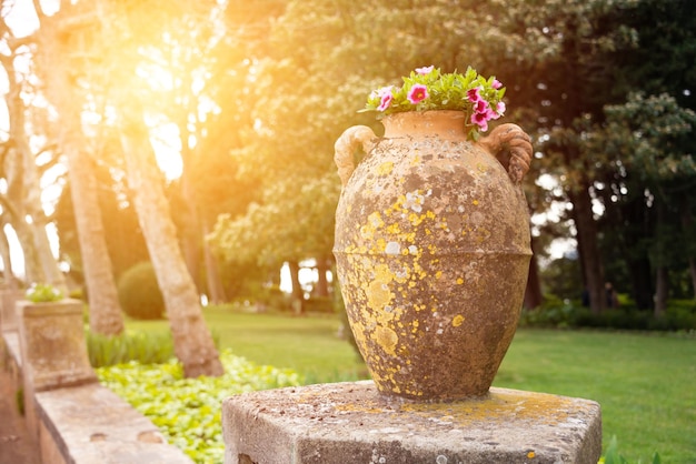 Old stone vase in a park or garden in Italy