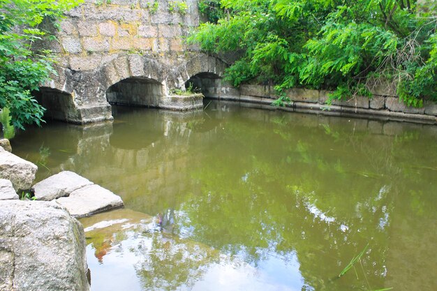 Old stone wall and river