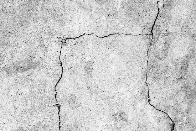 Old stone wall with crack, black and white textured background