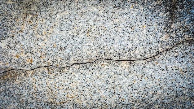 Old stone wall with a crack. texture for design