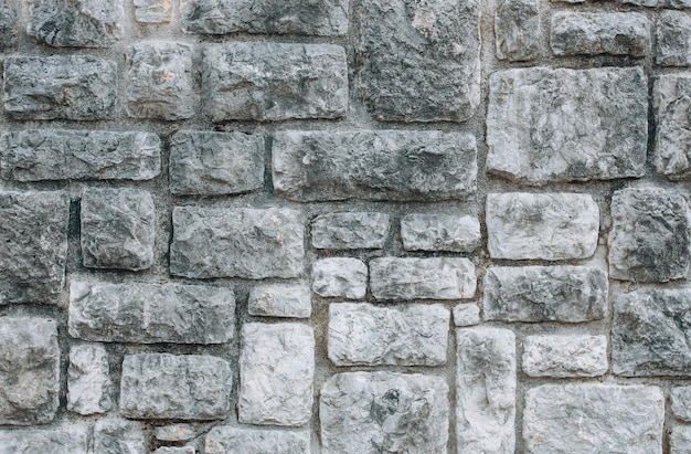 Old stone wall with gray brick