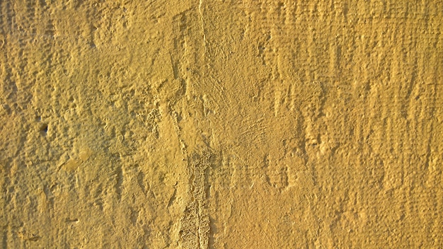 An old stone wall with yellow paint. Barground for Design. High quality photo